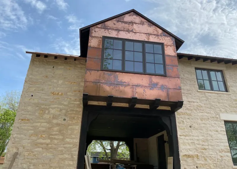 Copper metal panel facade on a stone building for Skylight Installation in San Luis